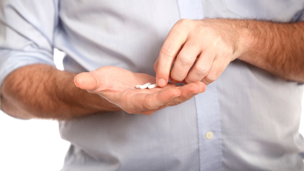 a man holding a small white object