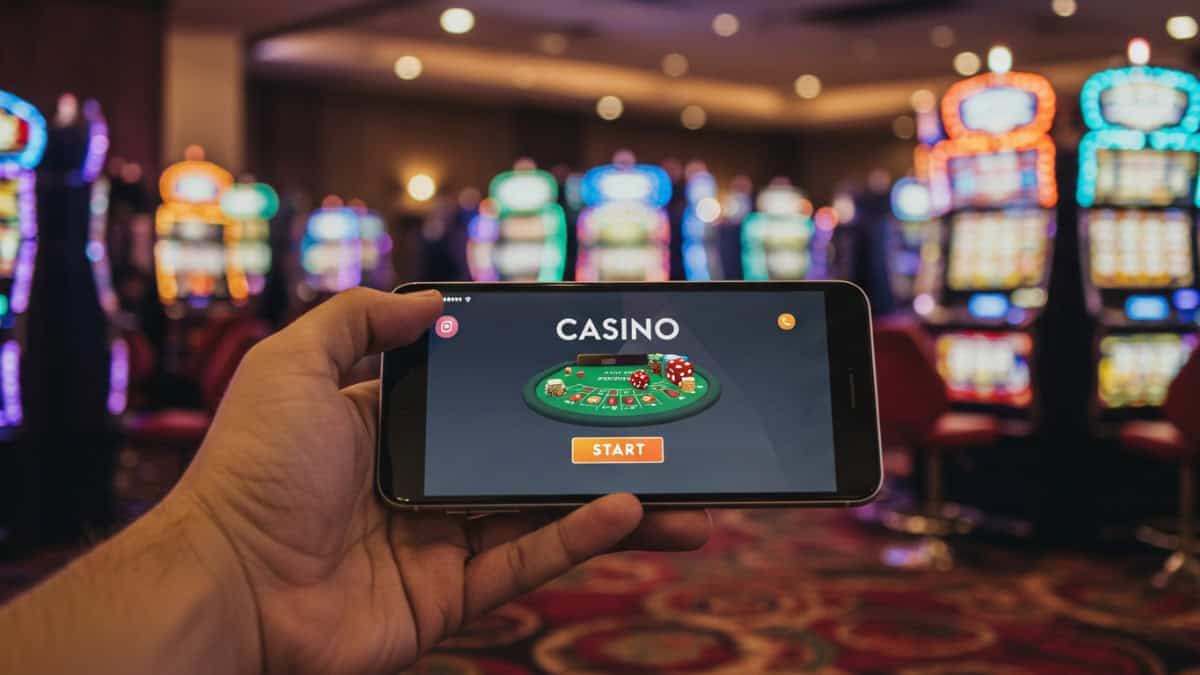 A person holding a phone showing an online casino app