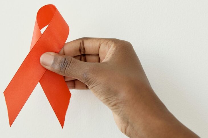 Holding AIDS ribbon